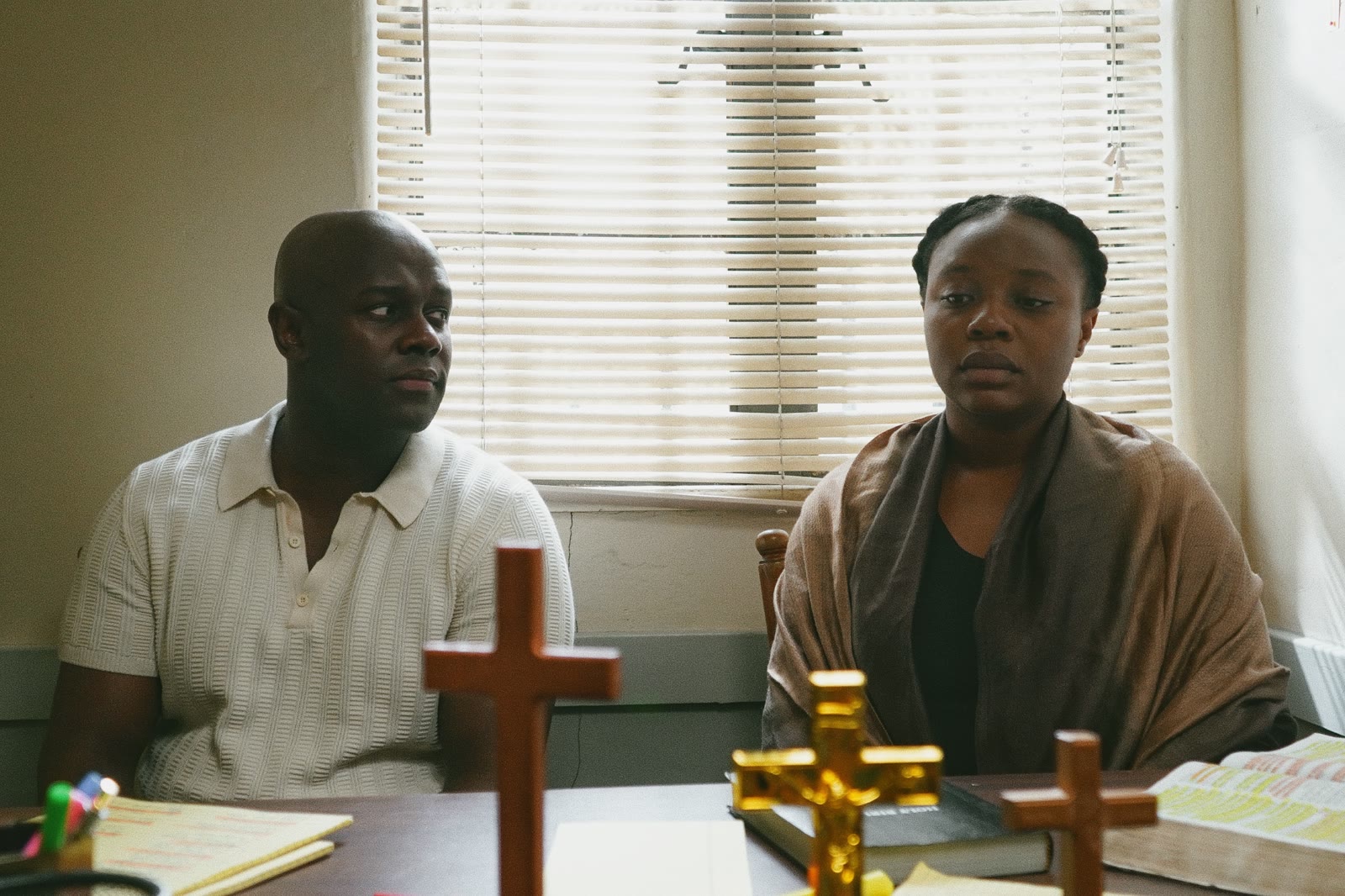 Still from FADING — a church interior with a wooden cross above the pulpit